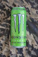 KYIV, UKRAINE - 4 MAY, 2023 Monster energy drink ultra paradise in green tin can with Monster energy drink logo photo