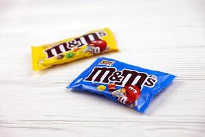 KHARKIV, UKRAINE - JANUARY 2, 2021 M and Ms colorful button shaped chocolate candies. Multi colored chocolates each of which has the letter m printed in lower case in white photo