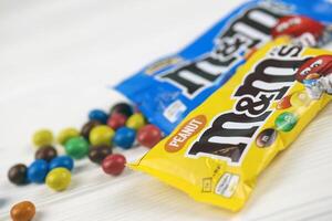 KHARKIV, UKRAINE - JANUARY 2, 2021 M and Ms colorful button shaped chocolate candies. Multi colored chocolates each of which has the letter m printed in lower case in white photo