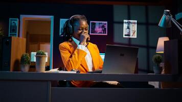 African american girl listening to professor debating latest lesson, taking notes after understanding explanations. Student participating at online school classes on academic platform. Camera B. photo