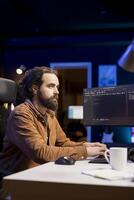 Cybersecurity professional using computer to look for company security vulnerabilities and dangerous malware. Programmer typing on keyboard, installing fortified code on PC to prevent cyber attacks photo