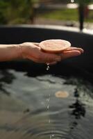 A hand splashes in a fragrant vat of citrus photo