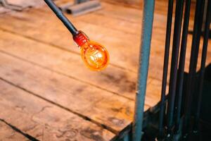 Molten glass is blown at the end of the pipe photo