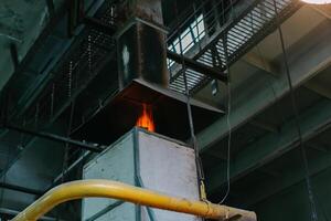 Working burning glass furnace in production photo