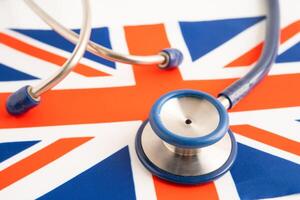 Stethoscope on United Kingdom flag background, Business and finance concept. photo