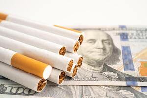 Cigarette on US dollar banknotes, cost, trading, marketing and production, No smoking. photo