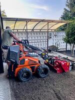 Nitra, Slovakia - 08.15.2023 Operation of a mechanical seeder. Planting a lawn. photo