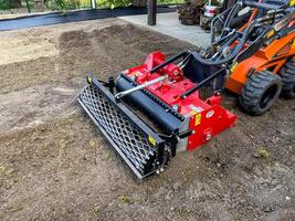 Nitra, Slovakia - 08.15.2023 Operation of a mechanical seeder. Planting a lawn. photo