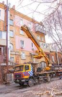 Dnepr, Ukraine - 03.20.2024 Mobile crane in the courtyard of an old apartment building photo