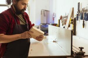 fabricante cosecha ideal madera bloquear a utilizar en huso moldeador, haciendo mueble ensamblando. carpintería experto utilizando pesado maquinaria a realizar varios fabricación Tareas foto