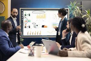 Team leaders attending meeting in a boardroom and talking sense into his employees, trying to identify challenges or obstacles hindering progress. Manager and staff struggling with a project. photo