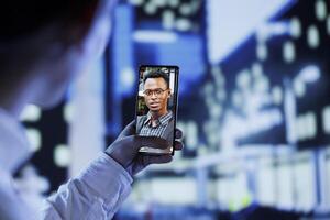 Close up of man in videocall with best friend while walking around city avenues at night, giving him work updates. Person uses laptop to show roommate dimly illuminated cityscape in blurry background photo