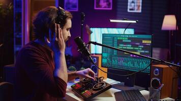 Sound producer recording backing vocals to add over tunes in home studio, using a mixing console to create a modern mix. Music producer mastering a new soundtrack with equalizer tool. Camera B. photo