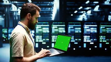 Expert using chroma key laptop to check server hub configuration settings, close up. Mechanic checking event logs in monitoring software to find broken data center components root cause photo