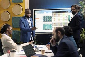 Business workers exchanging details and updates on a project, achieving organization goals and establishing budget or other resources. Operational team sharing information in a meeting. photo