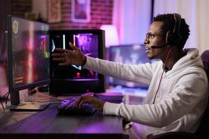 Frustrated gamer losing online multiplayer spaceship arcade racing game on powerful gaming PC. African american man shocked to see he is outskilled by more capable players photo