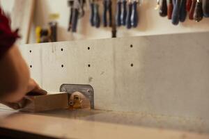 CNC machinist operating spindle moulder to create high quality bespoke joinery for client commissioned project. Carpenter performing tasks on wood shaper, shaping and cutting materials photo