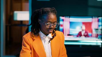 African american student working on her bachelor paper essay at home, writing ideas from online research. Girl exploring digital libraries and academic databases for additional resources. Camera A. photo