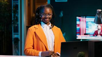 Portrait of university student sitting at her home desk using laptop to do school tasks. Young woman exploring career pathways and networking opportunities through professional platforms. Camera A. photo