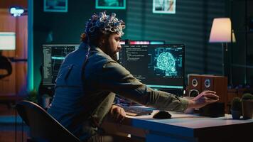 IT expert using EEG headset and machine learning to upload brain into computer, gaining immortality. Computer scientist develops AI experiment, inserting his persona into cyberspace, camera A photo