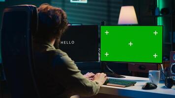 Programmer updating artificial intelligence algorithm using green screen PC, making it become sentient. IT specialist programming self aware AI with mockup computer, camera A photo