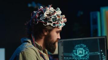 IT specialist using EEG headset and deep learning technology to upload brain into computer. Close up of neuroscientific equipment used by man transferring consciousness into cyberspace, camera A photo