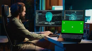 AI becoming sentient, chatting with computer scientist, asking existential questions, green screen laptop. Concept of artificial intelligence gaining consciousness, chroma key notebook, camera A photo