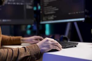 Freelancing cybersecurity admin using computer to look for company security vulnerabilities. IT engineer typing on keyboard, installing fortified code on PC to prevent cyber attacks, close up photo