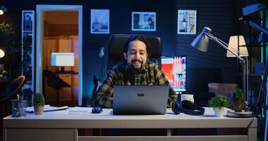 Man checking up on abroad living friend during conference meeting over the internet. Caucasian person enjoying time together with mate in online call session while at home, camera B photo