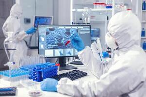 Team of medical engineers test blood to find a cure for coronavirus in science laboratory. Doctor working with various bacteria and tissue, pharmaceutical research for antibiotics against covid19. photo