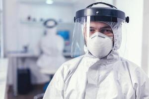 médico personal vistiendo protector equipo en laboratorio para codicioso investigación. muy trabajado investigador vestido en protector traje en contra invección con coronavirus durante global epidemia. foto