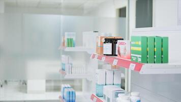 Selective focus of medicaments and supplements on shelves, empty pharmacy stacked with prescription medicine and medical supplies. Drugstore having antibiotics and pharmaceutics for sale. photo