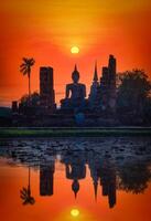 grande Buda a puesta de sol en wat mahathat templo, sukhothai histórico parque, tailandia foto