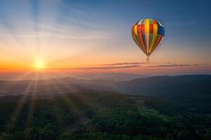 Aerial view of sunrise with ballon over mountian and pine tree in Chiang Mai Province, Thailand photo