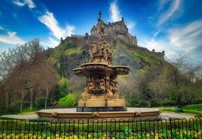 Ross Fountain in garden with Edinburgh Castle on blue sky at United Kingdom photo
