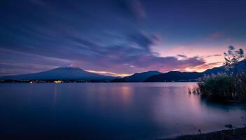 Landscape image of Mt. Fuji over Lake Kawaguchiko at sunset in Fujikawaguchiko, Japan. photo