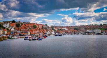 Whitby abbey is a seaside town and port at daytime in North Yorkshire, UK photo