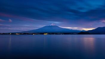 Landscape image of Mt. Fuji over Lake Kawaguchiko at sunset in Fujikawaguchiko, Japan. photo