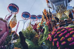 Salak yom at Wat Phra That Hariphunchai in Lamphun. The tradition of making merit, the tall dyed lott trees are decorated with different colored paper and clothing items to pay homage to the souls. photo