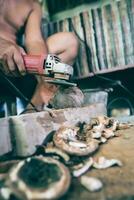 Using electric blades to sharpen coconut shells to be smooth. photo