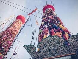 Salak yom at Wat Phra That Hariphunchai in Lamphun. The tradition of making merit, the tall dyed lott trees are decorated with different colored paper and clothing items to pay homage to the souls. photo