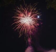 Fireworks explode in the dark sky celebrating the annual festival. photo