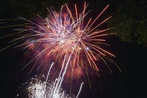 Fireworks explode in the dark sky celebrating the annual festival. photo