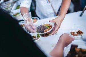 Poor people receive donated food from donors photo