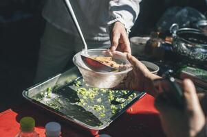 Volunteers distribute simple meals to the poor at the free food kitchen. photo