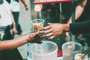 Distributing food to help the poor in society Sharing food to the hungry Food donation concept photo