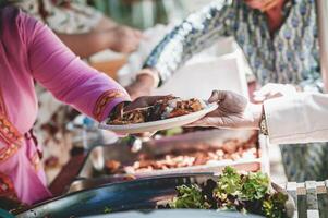 Homeless people reach out to receive free food that volunteers bring. to help alleviate hunger photo