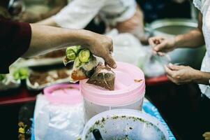 concept of charity food for the poor . the concept of life problems, hunger in society . Helping People With Hunger With Kindness. The hands of beggars receive donated food photo