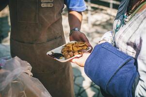 Volunteers serving hot meals to hungry migrants humanitarian aid concept. photo