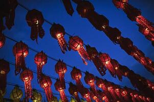 Lanterns made of colorful paper are hung during the annual festival at Wat Phra That Hariphunchai in Lamphun Province. photo